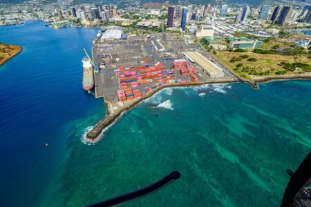 Aerial view of a large shipping container port with stacked cargo containers