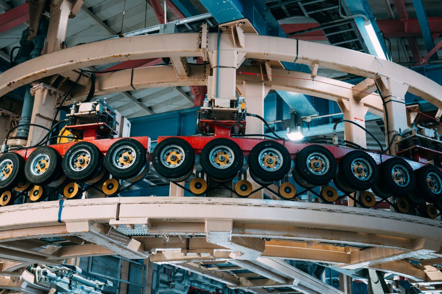 Workers on a manufacturing floor surrounded by industrial machinery and production equipment