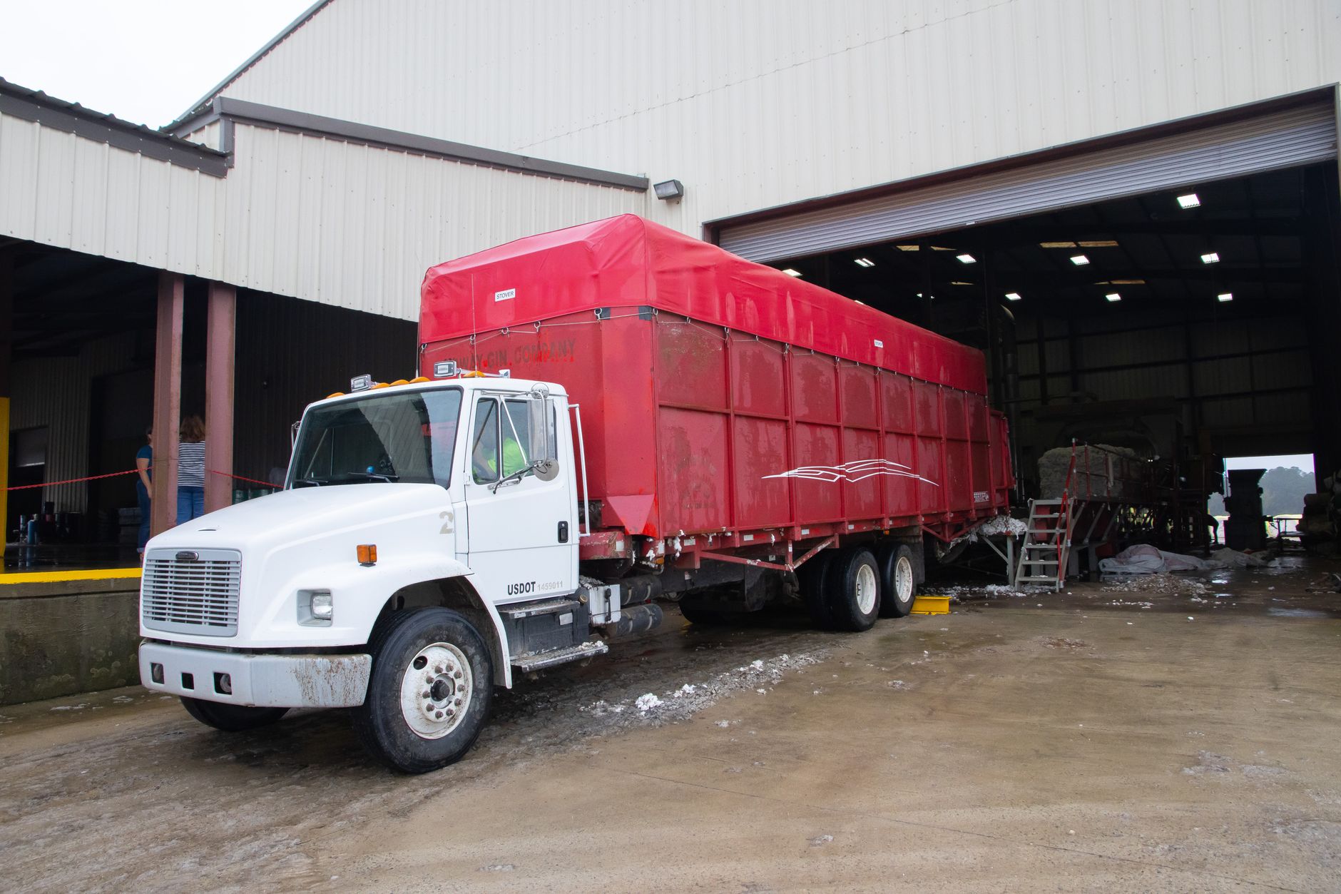 Commercial trucks lined up at a freight loading dock