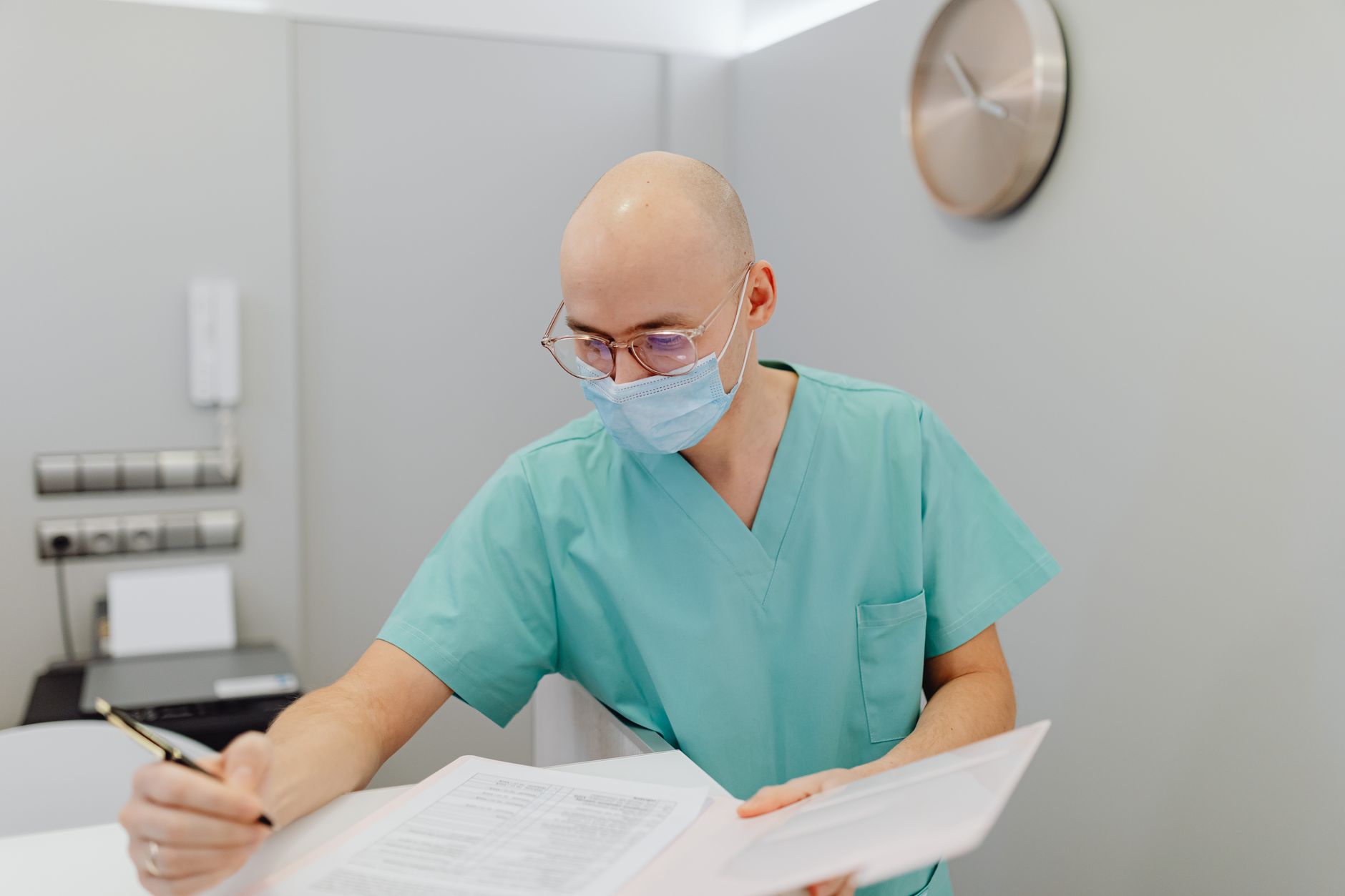 Doctor reviewing medical paperwork during a physical examination appointment