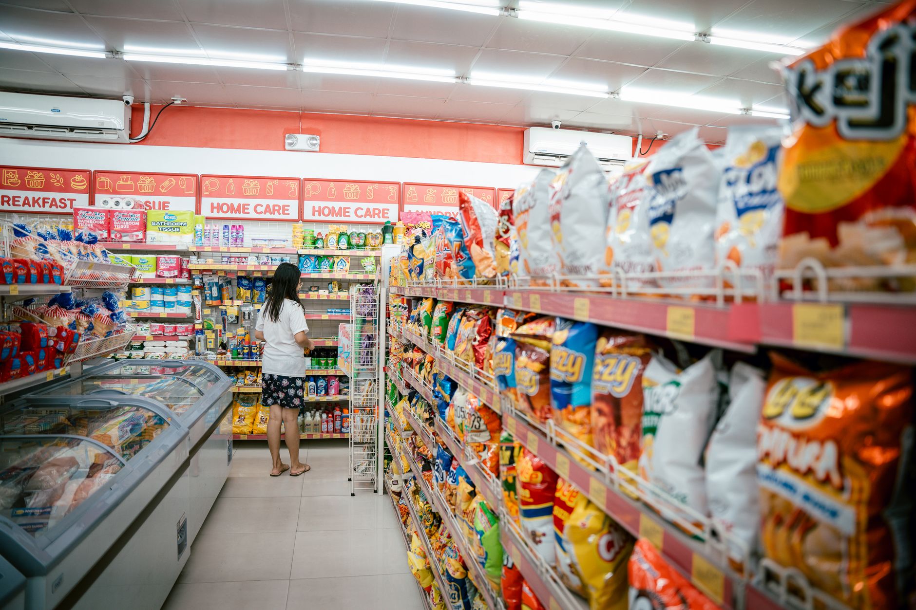 Wide shot of a grocery store aisle stocked with packaged food products