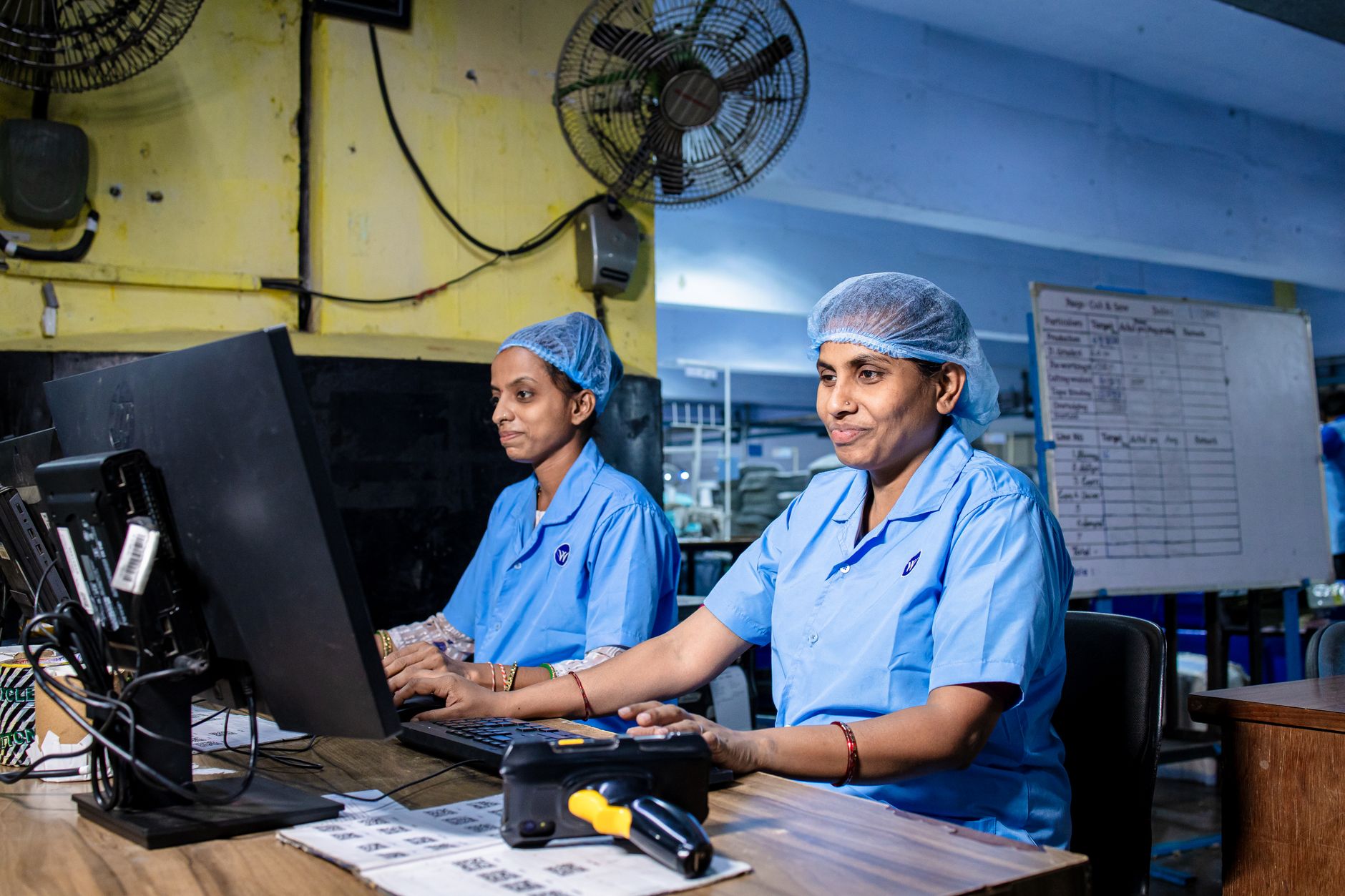 Industrial workers in hard hats on a manufacturing floor