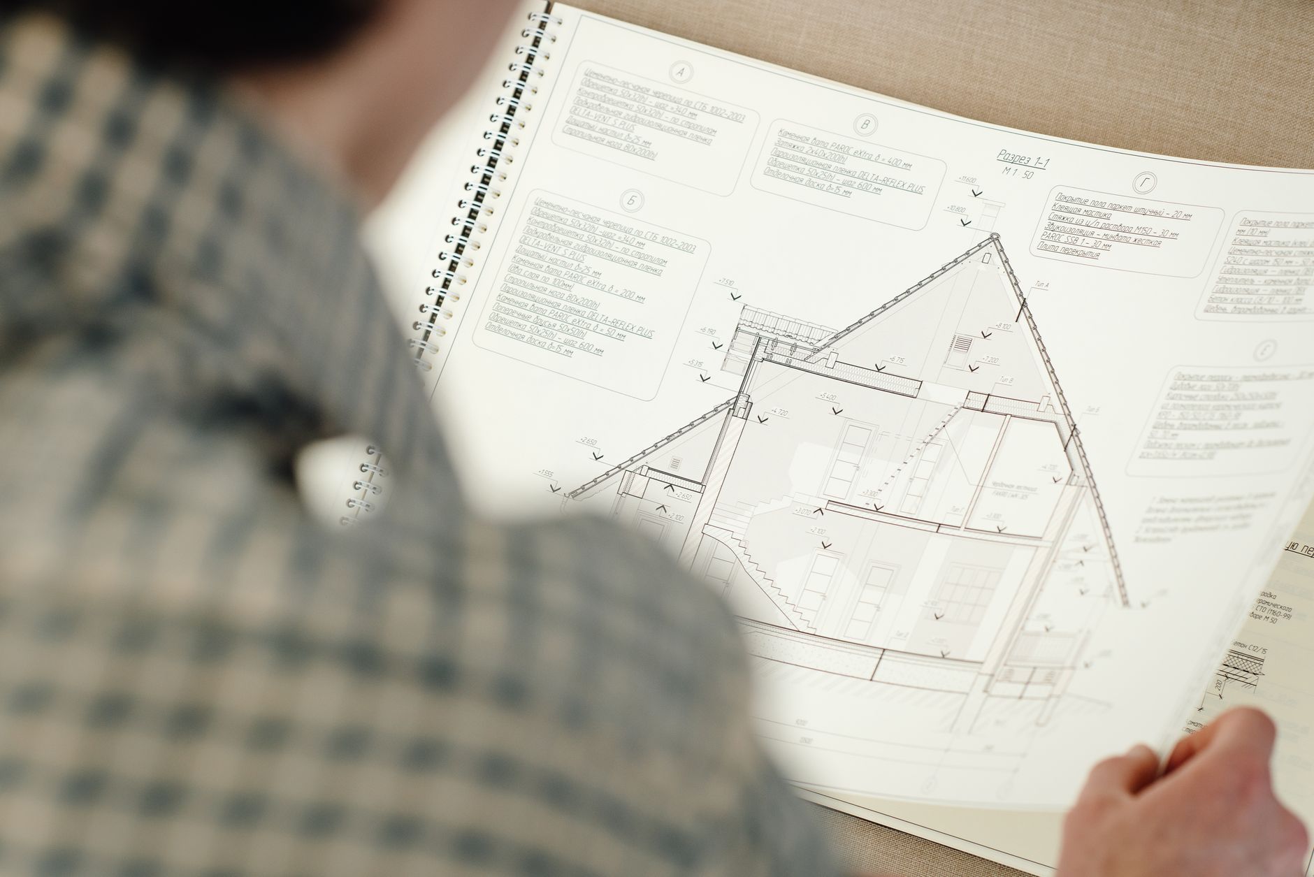 Architectural blueprint and planning documents spread across a table for a residential housing project