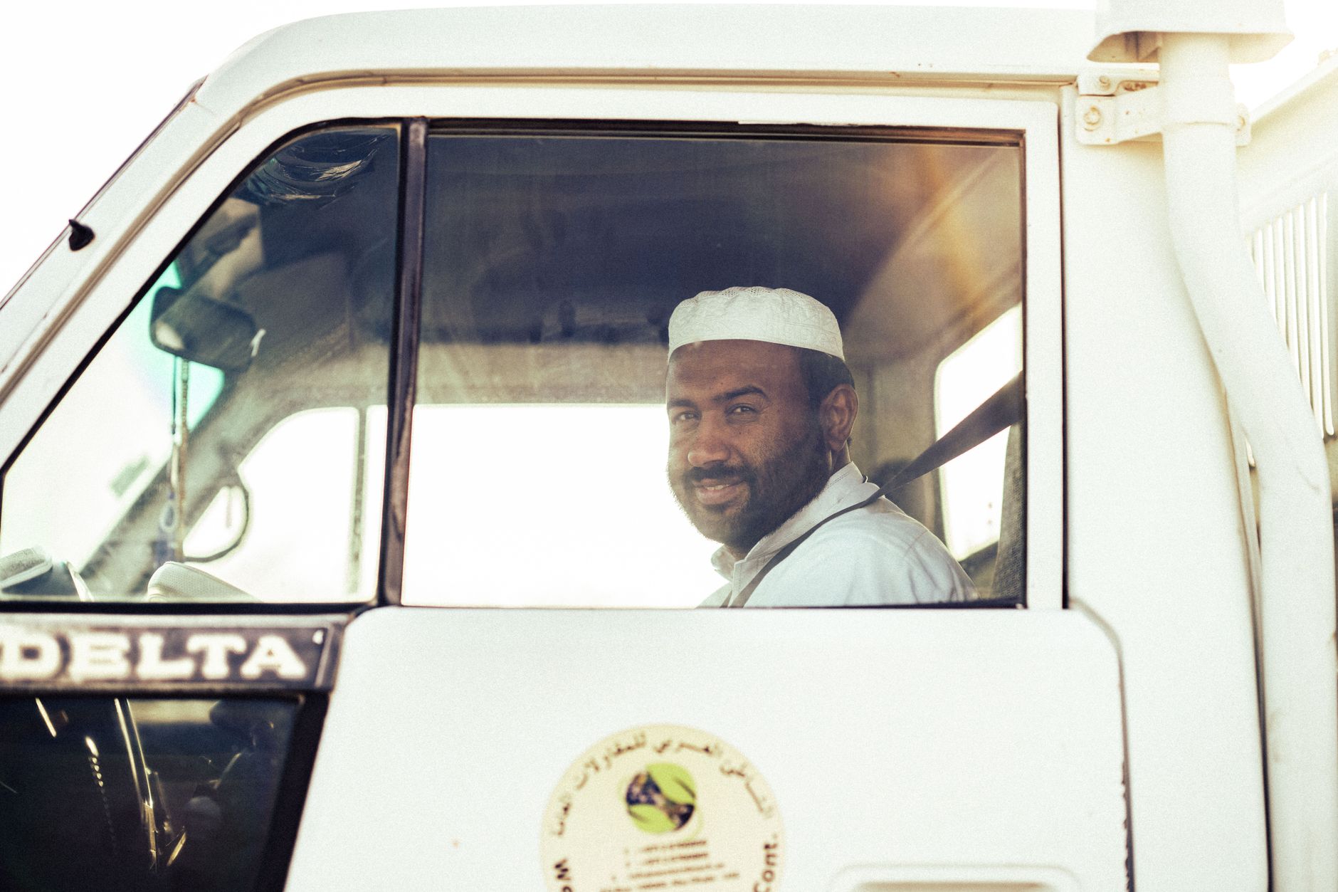 Male truck driver standing near his commercial vehicle looking concerned