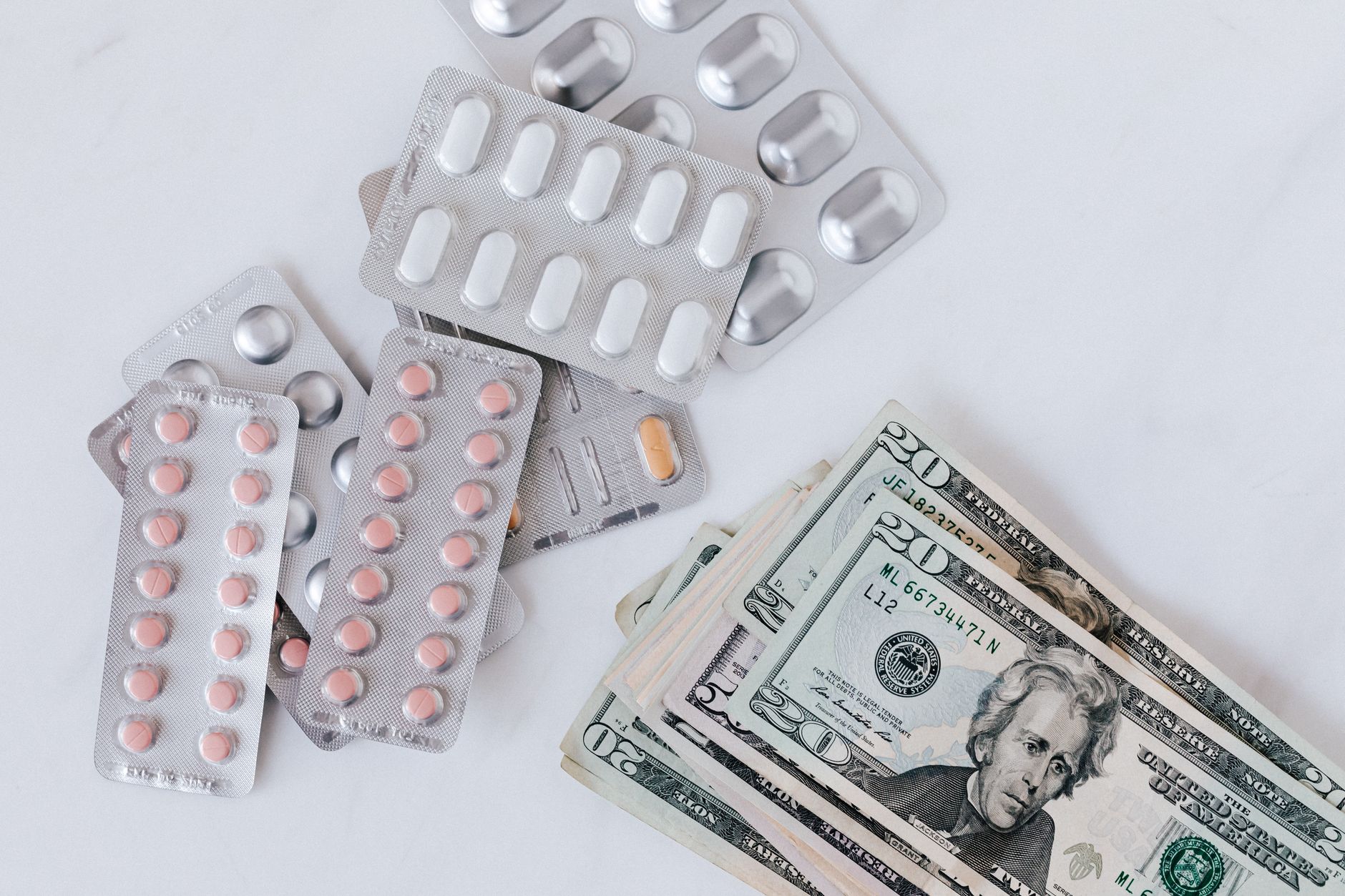 Person reviewing medical bills at a table, representing financial burden of losing health insurance coverage