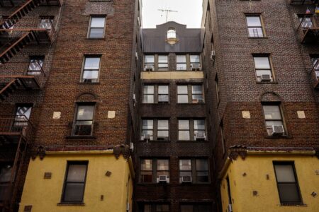 Exterior of a multi-unit residential rental building representing housing instability