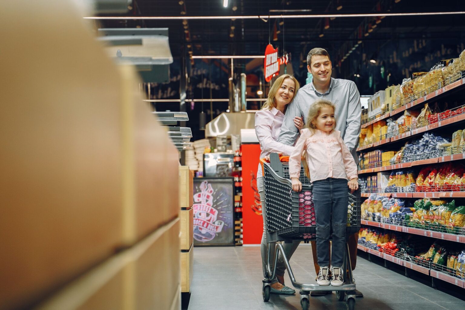 A shopper browsing products on a grocery store shelf