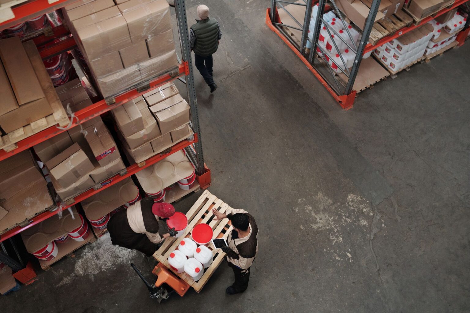 Tariff-Driven Reshoring Bets Collide With Weak Domestic Demand Workers on a domestic manufacturing factory floor during production shift