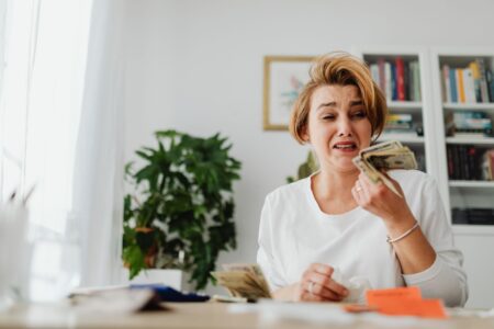 Student Loan Default Surge Strains Federal Credit Budget Outlook Stack of student loan paperwork and financial documents on a desk