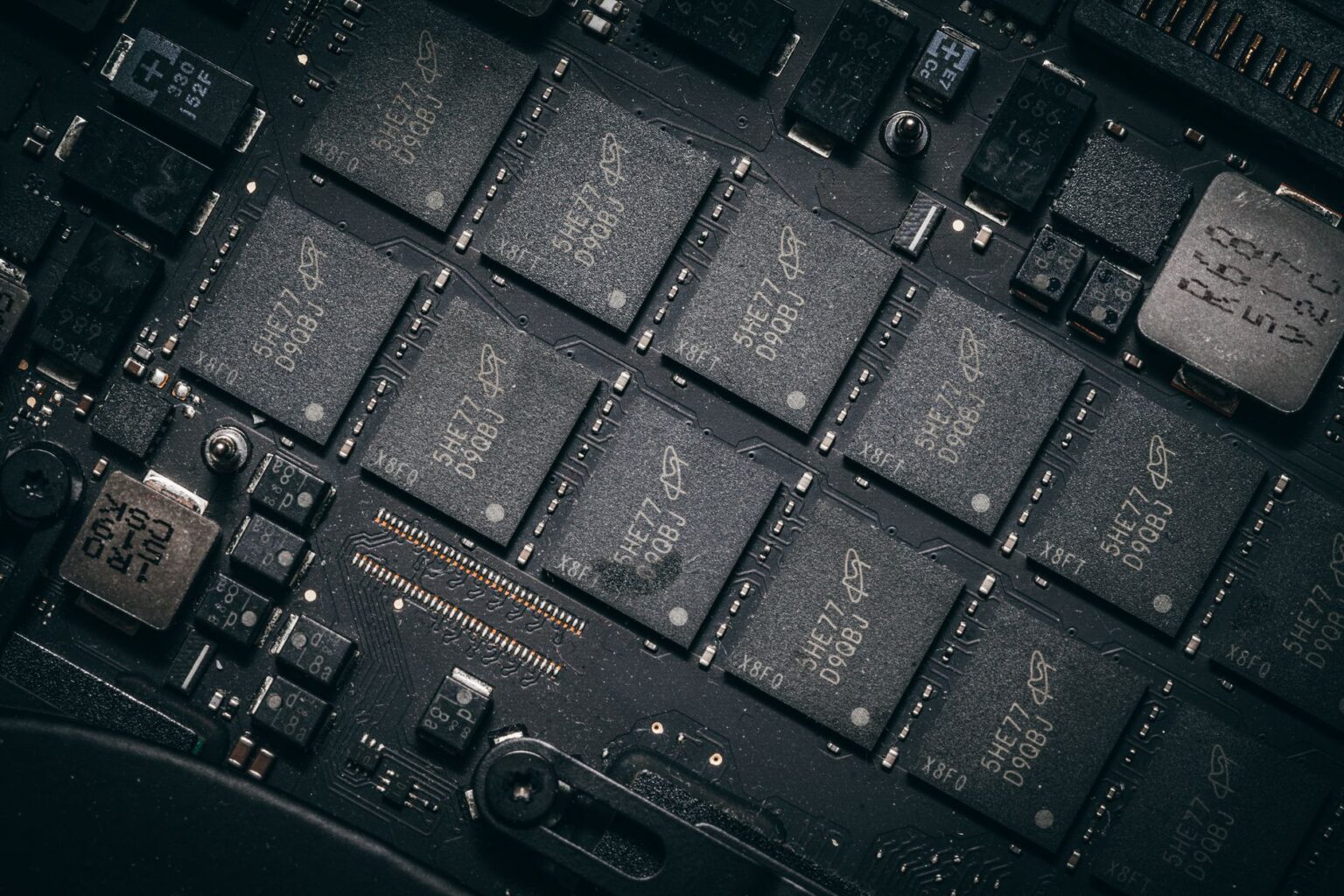 Workers on a semiconductor manufacturing floor surrounded by chip production equipment