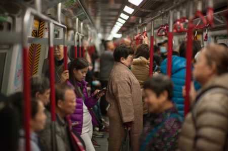 Federal Work-From-Home Rollback Strains Urban Transit Budgets Commuters crowding a busy urban subway platform during morning rush hour