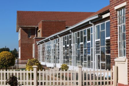 Exterior of a public school building on a quiet street