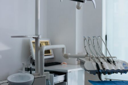 Empty dental examination room with chair and equipment in a small clinic