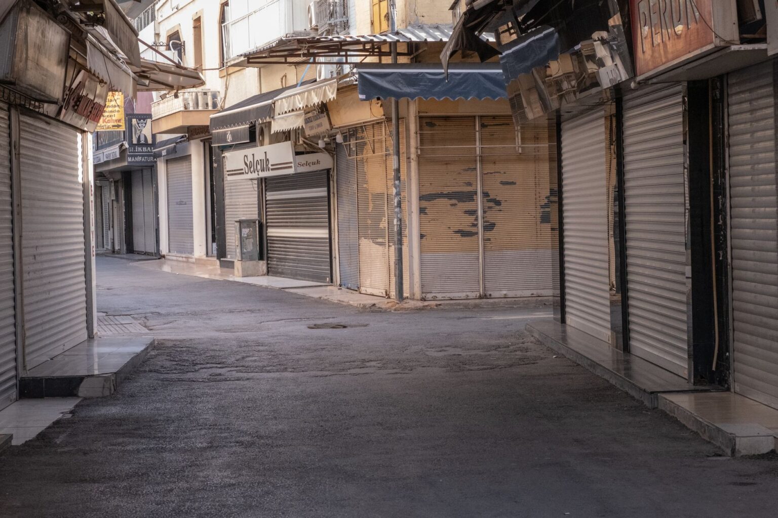 Vacant commercial storefront with paper covering windows in an urban street