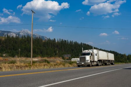 Semi truck driving on a highway representing freight transportation industry