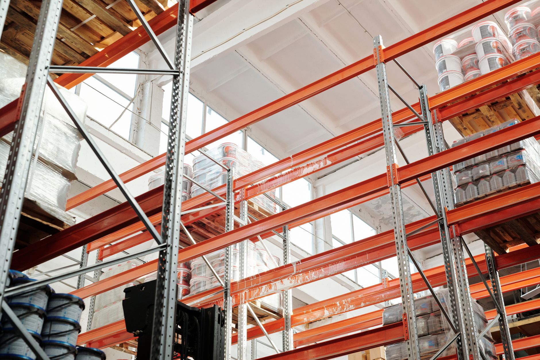 Large warehouse filled with stacked pallets of goods representing pre-tariff inventory stockpiling