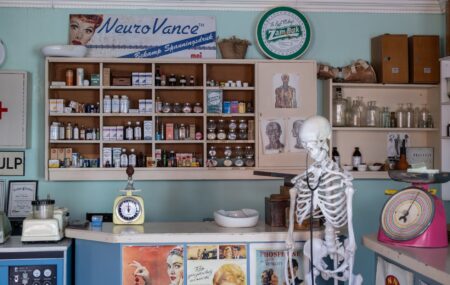 Retail Pharmacy Closures Leave Low-Income Neighborhoods Without Prescription Access Empty retail pharmacy shelves and closed counter in an urban neighborhood