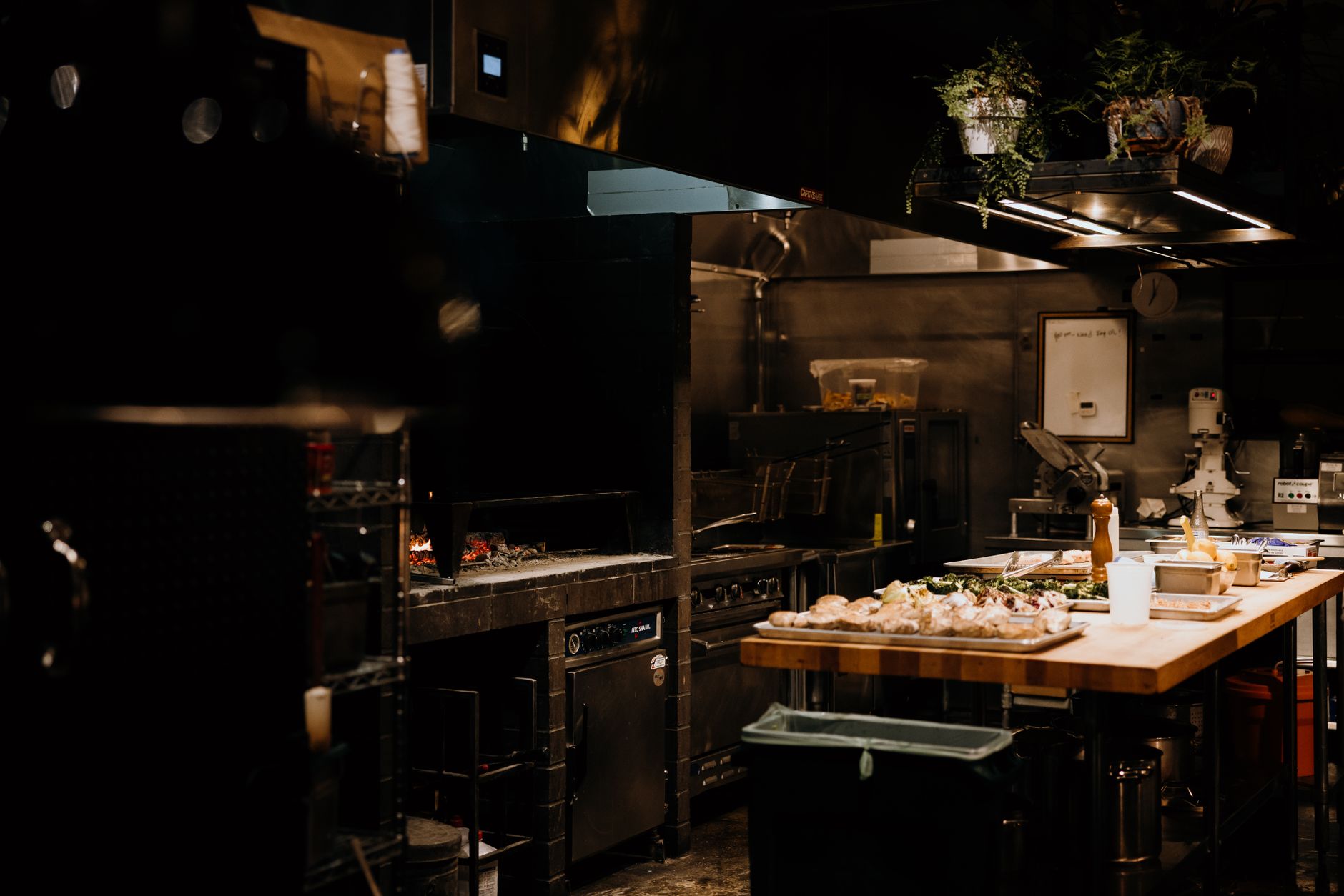 Restaurant kitchen staff preparing large catering order