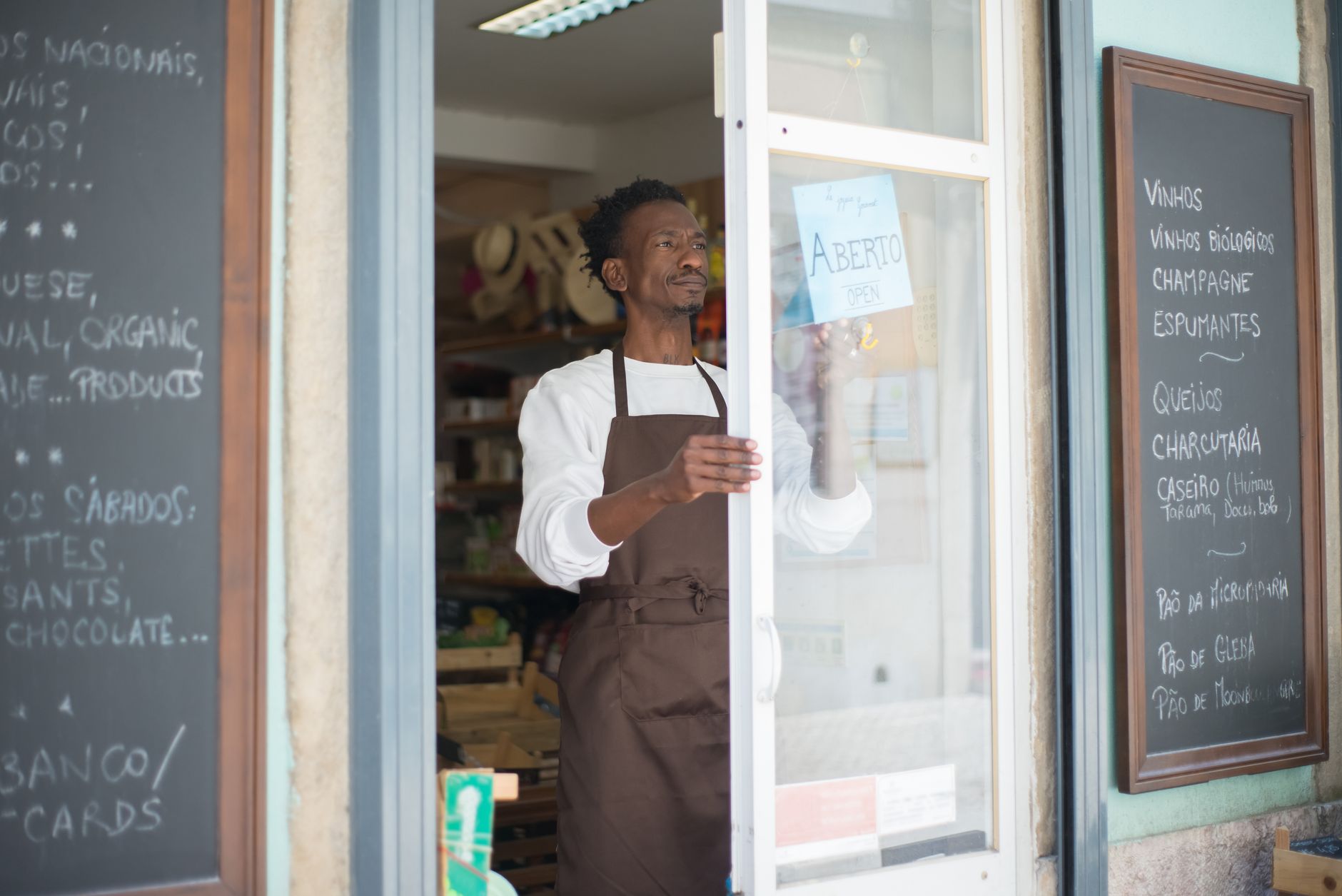Small business owner reviewing documents at a counter inside a retail shop
