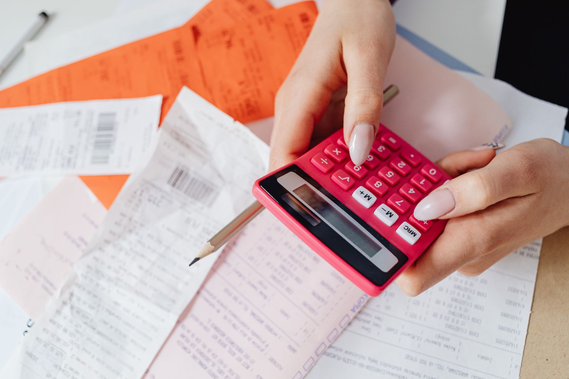 Healthcare billing administrator reviewing financial documents at a desk