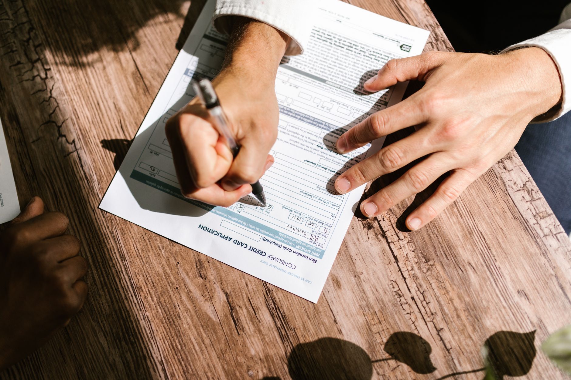 Close-up of financial paperwork and a pen on a desk representing loan repayment documentation