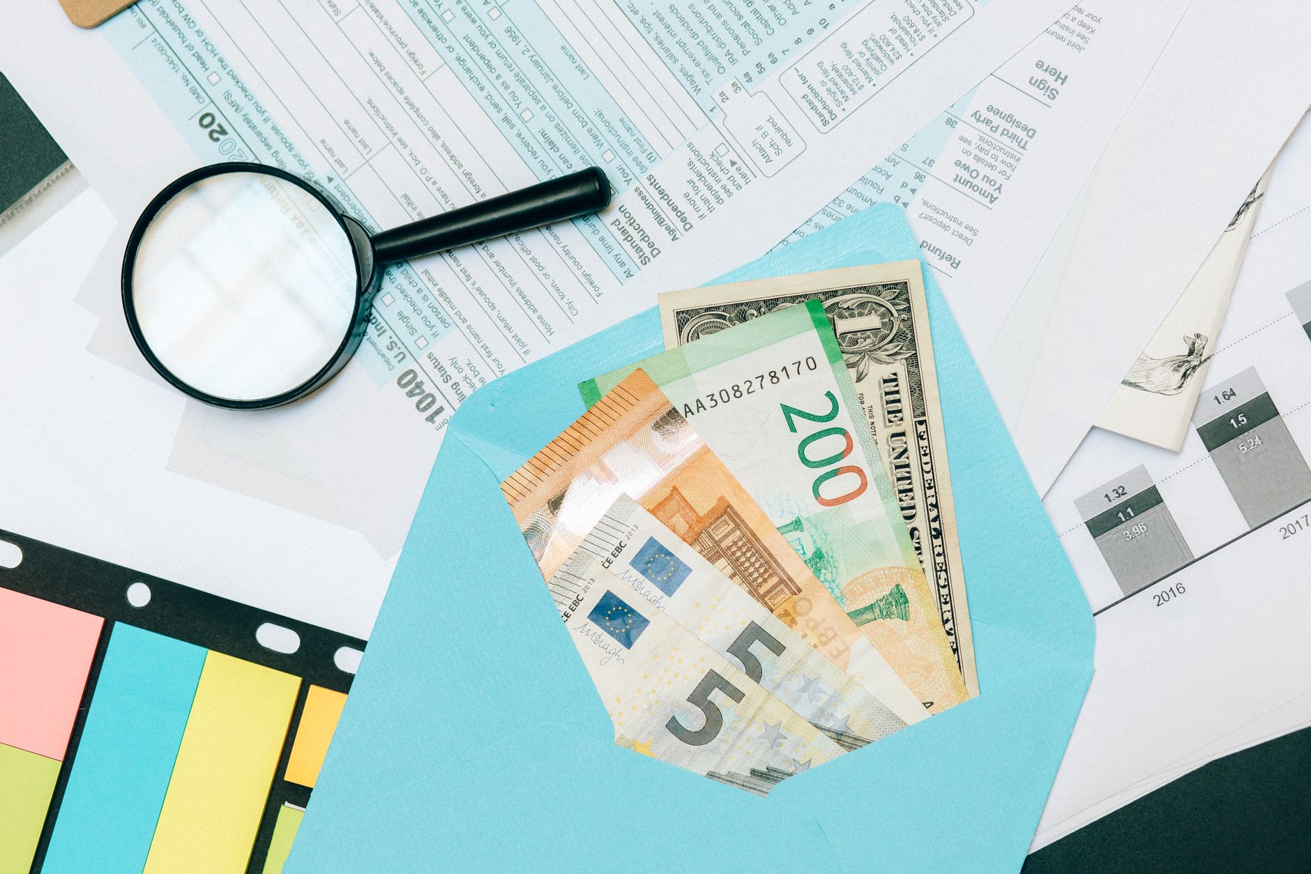 Business professional reviewing expense reports and receipts at desk